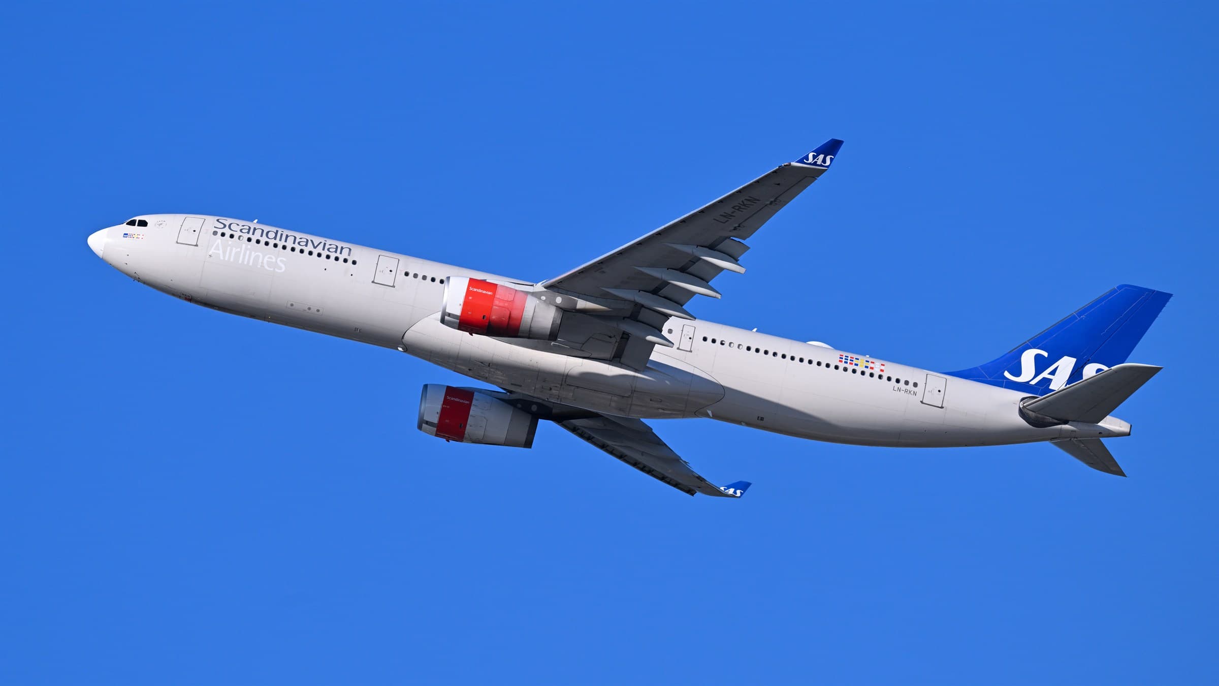 SAS Airbus A330-300 LN-RKN climbing after take-off against a clear blue sky